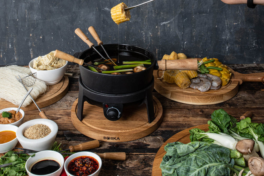 Fondue Burner Burning Below A Cast Iron Cooking Pot At A Restaurant Table  Stock Photo - Download Image Now - iStock