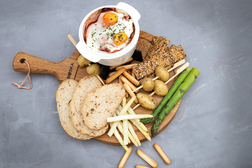 Oven-baked camembert with ham, egg and spring vegetables